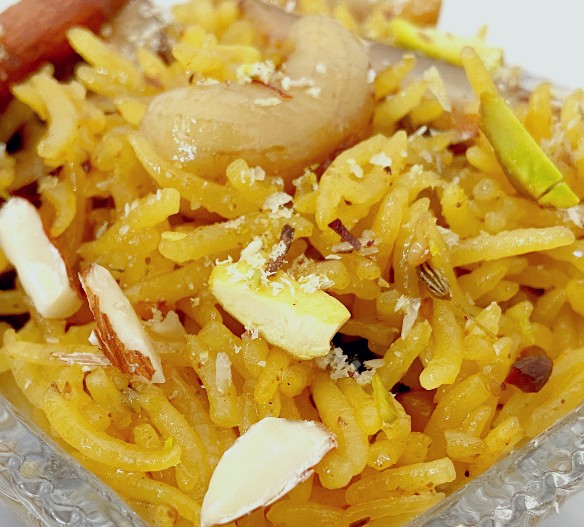 Sweet Zarda rice, flavored with saffron and orange, sweetened with gur