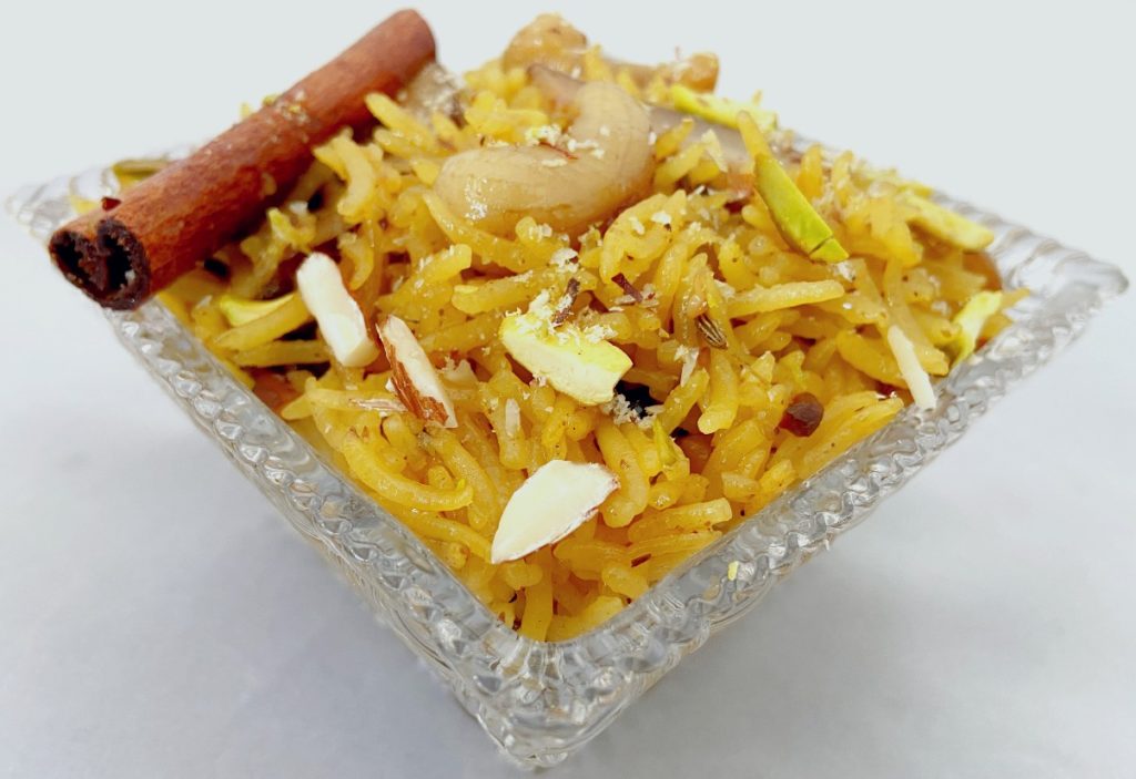 Sweet Zarda rice, flavored with saffron and orange, sweetened with gur